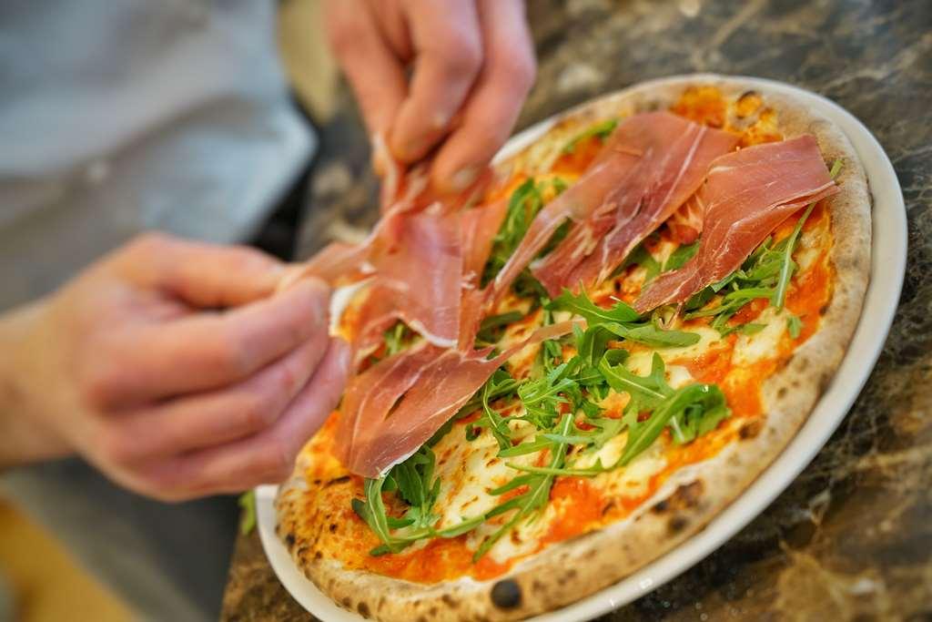 Vila Vita Rosenpark Marburg Exterior photo Pizza being topped with prosciutto
